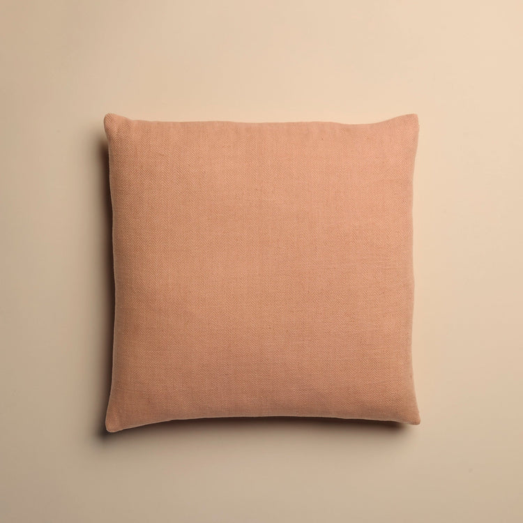 dusty pink pillow on a beige background