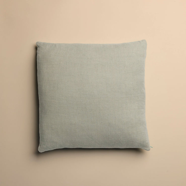 light blue pillow on a beige background