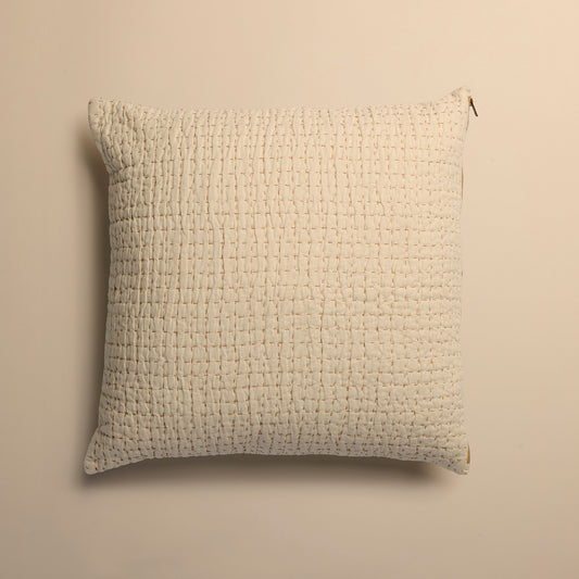 ivory textured square pillow on a beige background