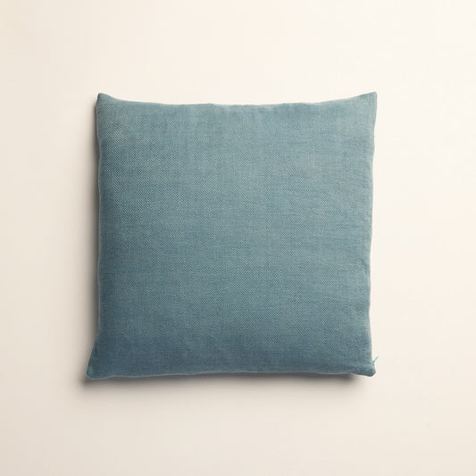 Blue pillow cover/ cushion on a light beige background