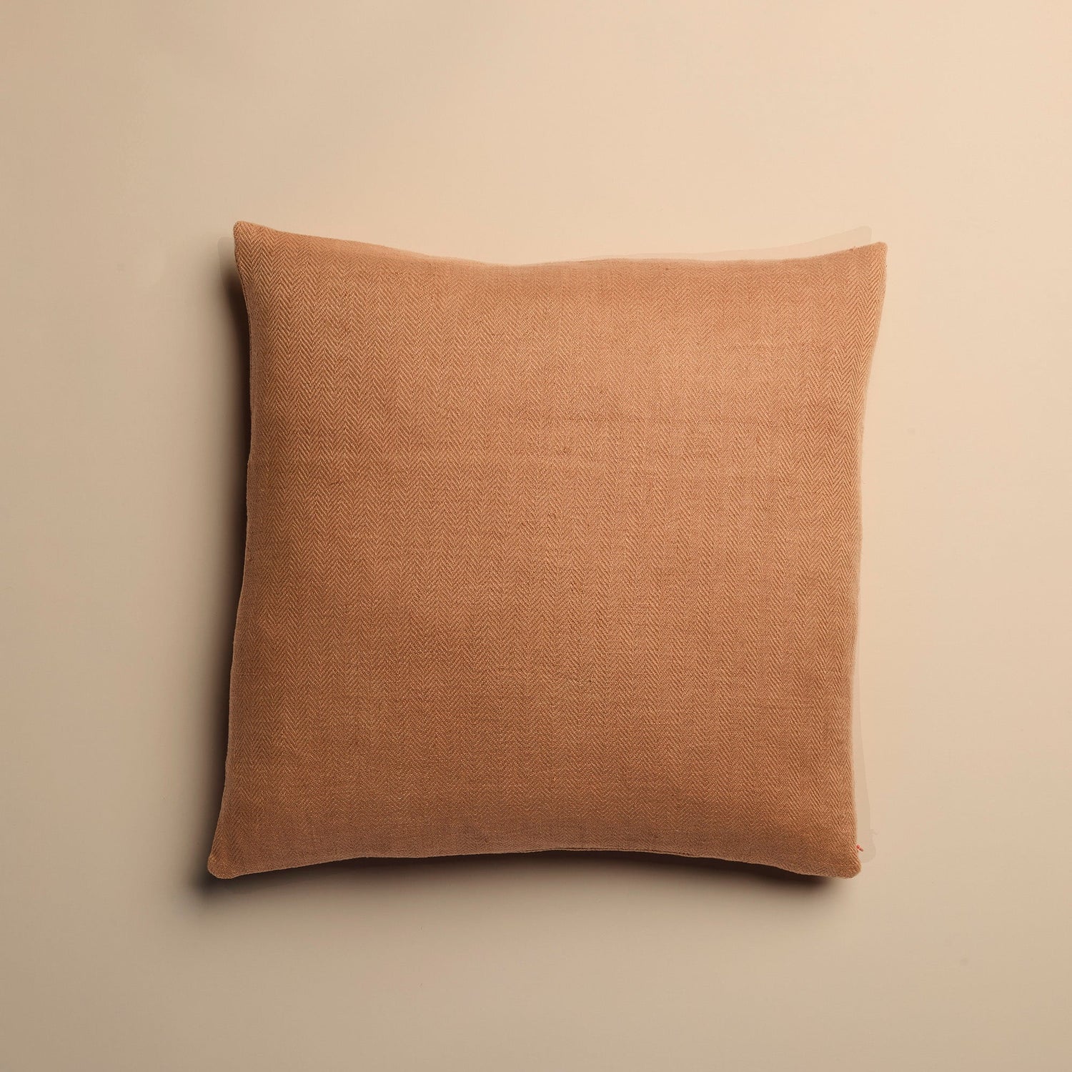 clay pink pillow on a beige background
