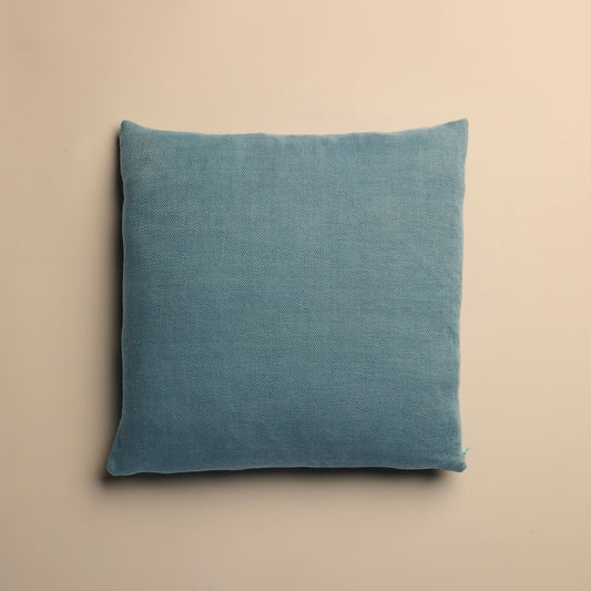 Blue pillow on a beige background