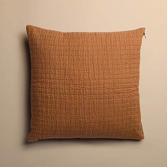 copper textured pillow on a beige background