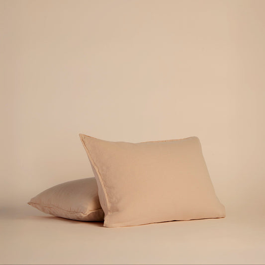 Two peach shams on pillows on a beige background