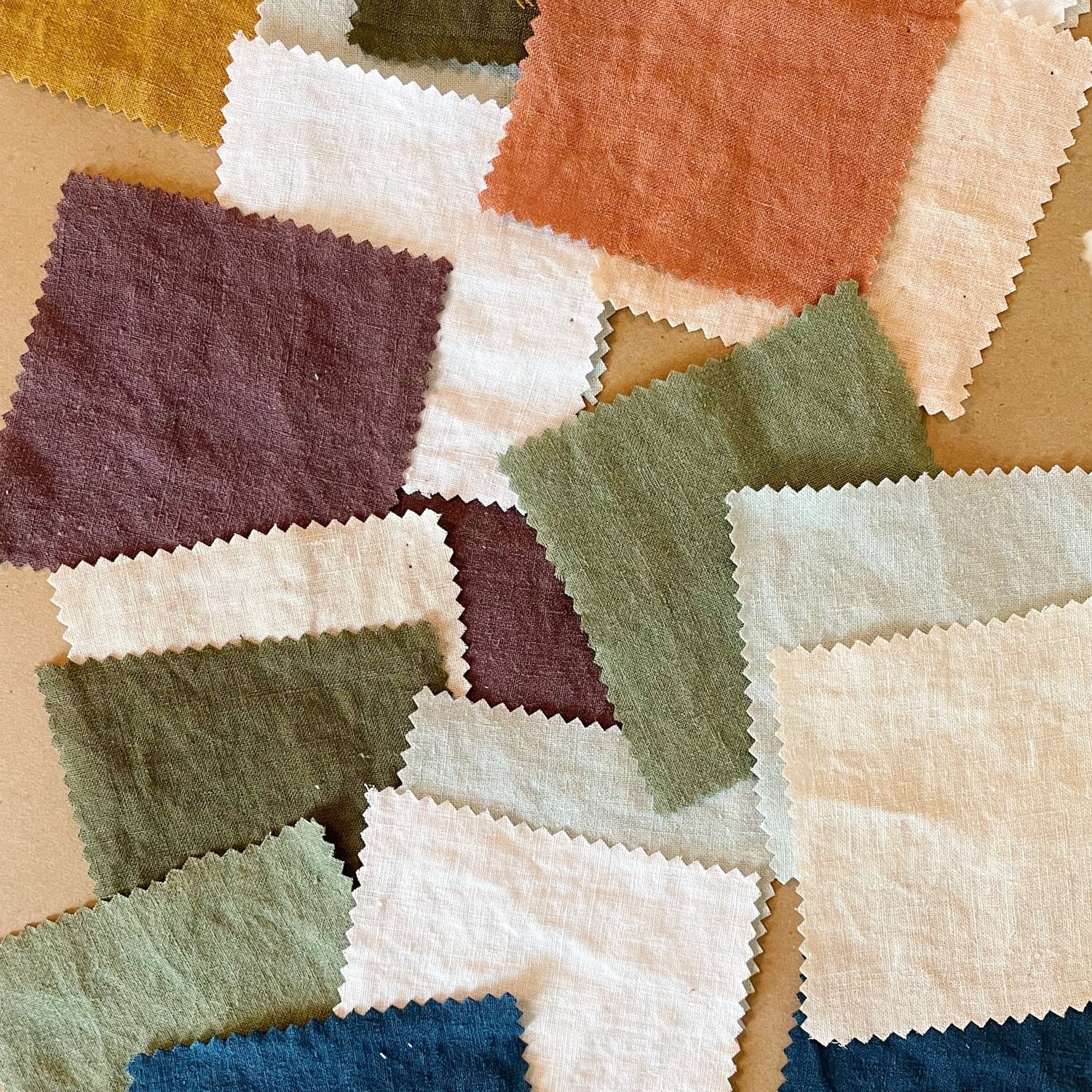 A collection of fabric swatches in various colors laid out on a surface.