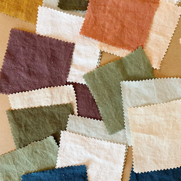 A collection of fabric swatches in various colors laid out on a surface.