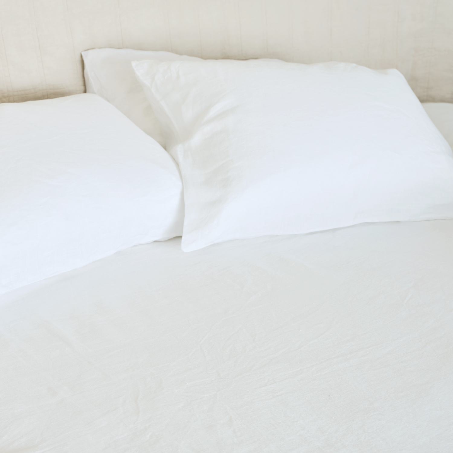 cool, relaxed white sheet on minimal bed with illows with white pillowcases