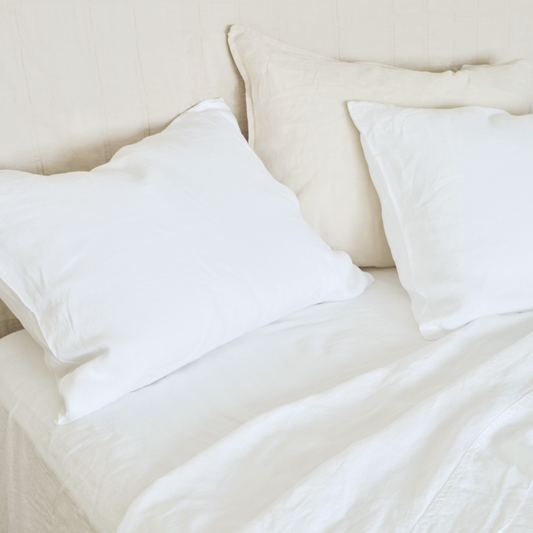 cool, relaxed white hemp sheets on bed with natural headboard