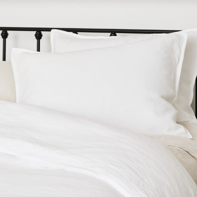 White hemp shams displayed on a bed with a focus on the soft texture and breathable fabric.